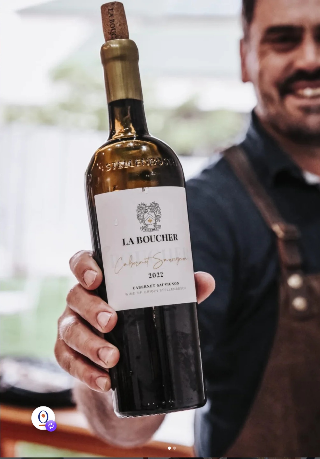 Kwagga Boucher holding a bottle of La Boucher Cabernet Sauvignon